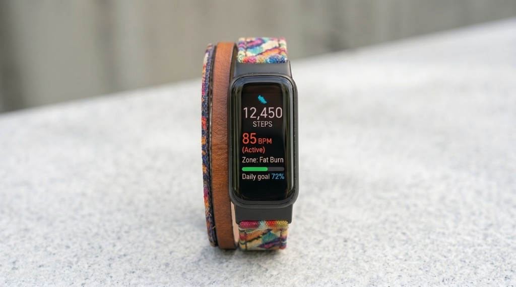 Fitbit-style fitness tracker showing steps and heart rate